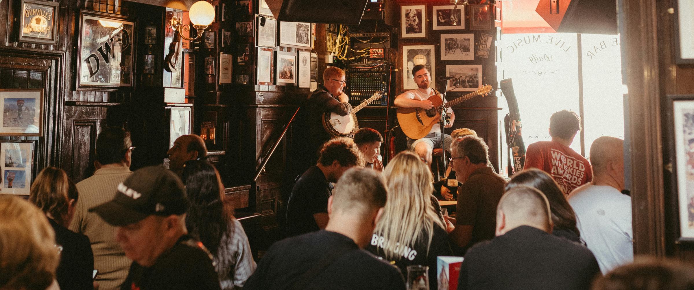 A trad session in a busy Belfast bar